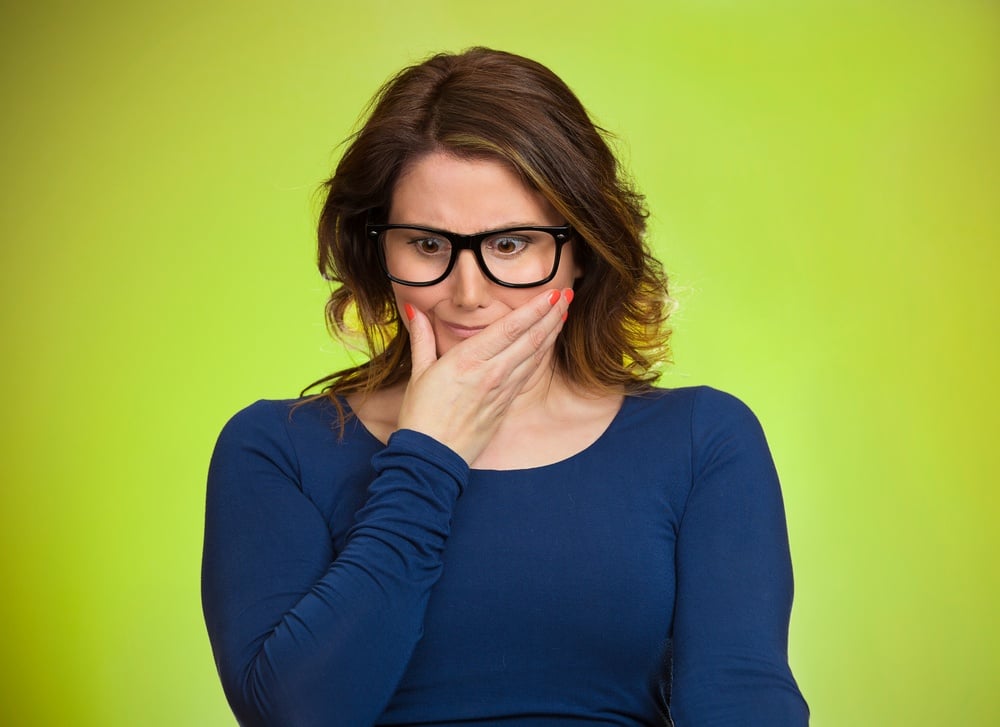 Awkward situation. Portrait embarrassed woman anxiously thinking how to get out of this, isolated green background. Human face expressions, emotions, feelings, reaction, life perception.jpeg